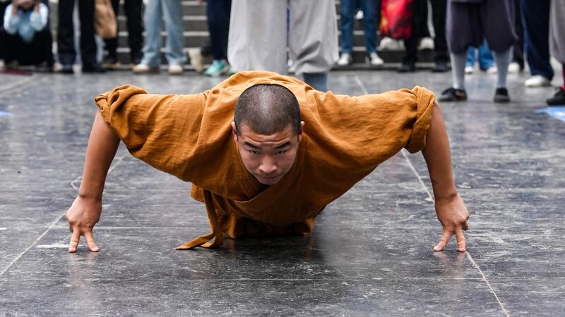 Defying Gravity Shaolin Monks Perform the Two finger Stand 